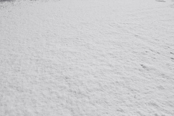 Texture of fresh snow covering the ground in winter .