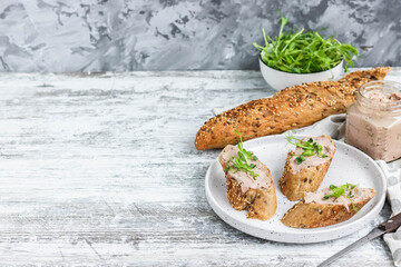 Turkey liver pate on whole grain baguette with microgreens. Copy paste