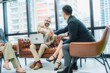 Naklejka premium Two confident business man shaking hands during a meeting in the office, success, dealing, greeting and partner concept.