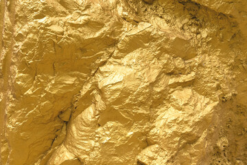 Gold paint stone or rock texture glitter abstract on background.