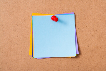 Colorful memo pads on the cork board
