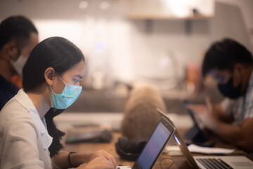 creative worker team wearing face mask, working at business co-working space