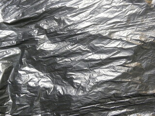 Black color garbage bag textured background