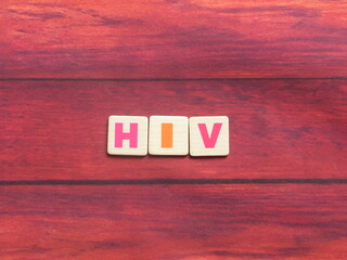 Abbreviation HIV (Human Immunodeficiency Virus) on wood background