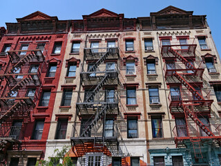 New York City, colorful old fashioned apartment buildings with external fire ladders