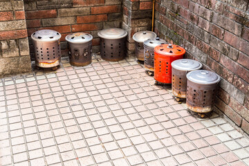 Two rows of burning paper barrels. People in Taiwan burn ritual money made of paper to the Gods or the dead in this kind of barrels.