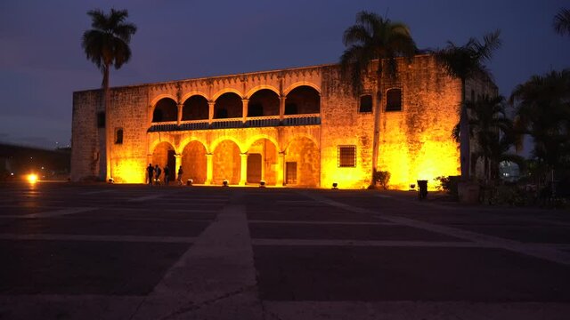 View of the Alcazar de Colon in Plaza Espa&ntilde;a, night shot orange lights illuminated the majestic building