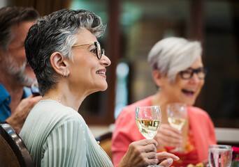 senior citizens drinking wine in restaurant