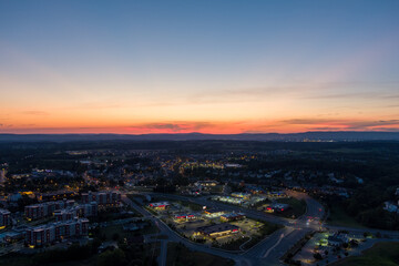 Fototapeta na wymiar Aerial view of Urbana, Frederick County, Maryland at dusk. Catoctin Mountain, part of the Blue Ridge Mountains, is on the horizon.