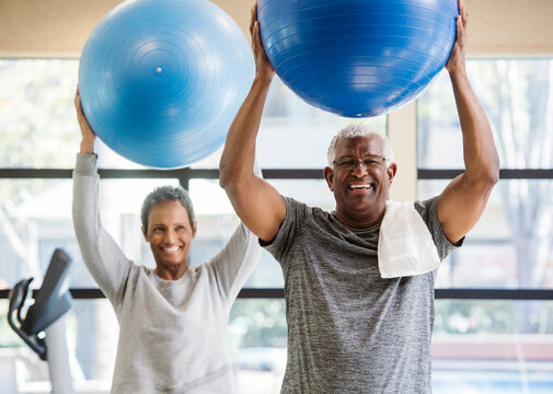 happy senior couple exercising in gym - Powered by Adobe