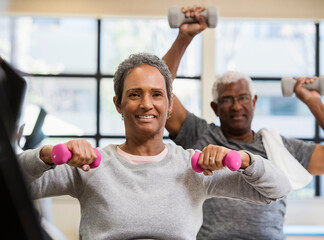 happy senior couple exercising in gym