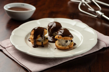 chocolate cream and cocoa profiteroles with hot melted dripping topping