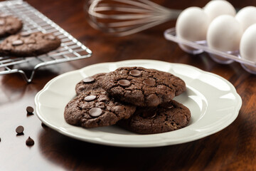 chocolate cocoa cookies with chocolate chips. background with tray and recipe ingredients