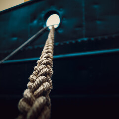 Rope that tied the ship close-up on the background of the ship's side.