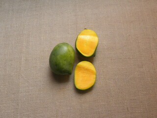 Whole and cut green and yellow ripe Kalaphad mangoes