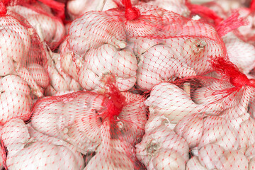 Garlic in red net bags.