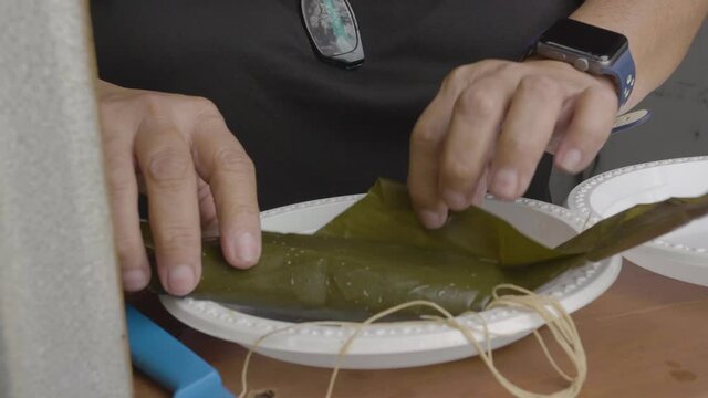 woman unwrapping puerto rican food