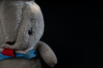 doll for a happy feeling on black background 