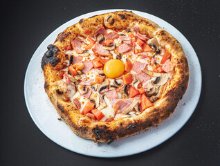 pizza on the black background, top view