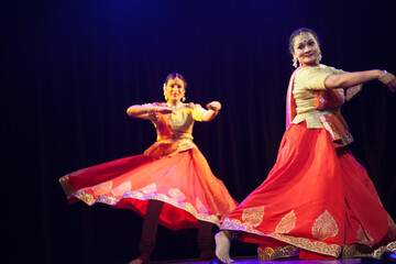 Two beautiful kathak dancers dancing ad frozen in time