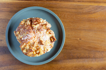 Close up of fresh baked banana walnut ready to eat on vintage wood kitchen table. 