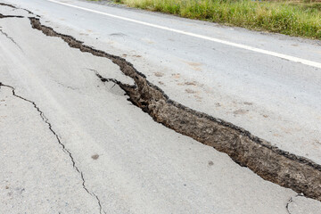 Cracked and broken asphalt road.