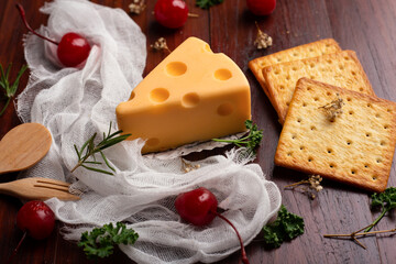 Cheese cake with red cherry on wooden table.