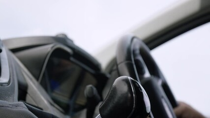 Male hand changes gear pulling gearstick down and indicates in delivery van, slow motion.