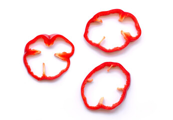 Slice of red bell pepper on white.