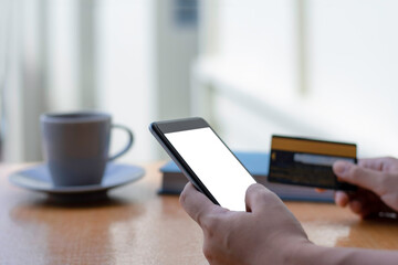 woman hand using smartphone and credit card.