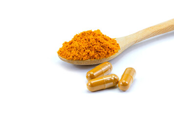 Turmeric powder capsules on white.