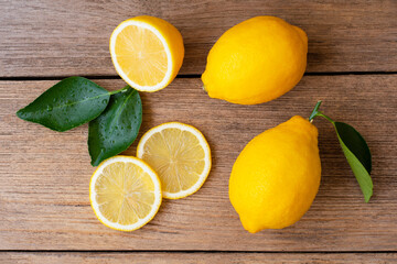 lemons and  green leaf on wood table.