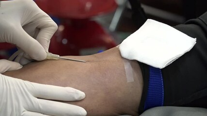 Blood donor at donation with a bouncy ball holding in hand.Also concept image for World blood donor day-June 14.