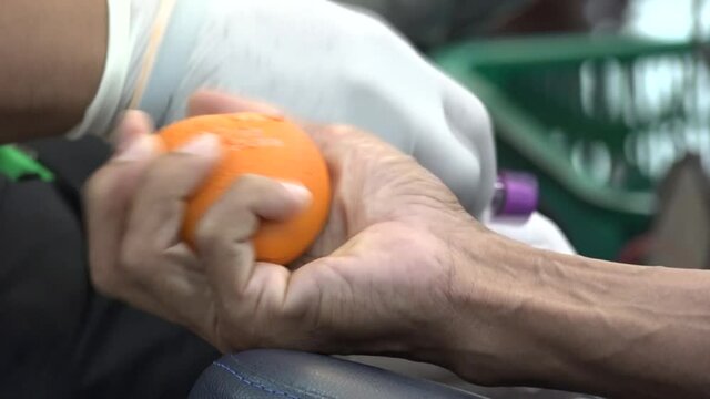 Blood donor at donation with a bouncy ball holding in hand.Also concept image for World blood donor day-June 14.