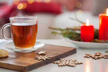 cup of tea with burning candles at home