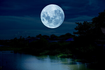 Fototapeta na wymiar Full moon over river in the night.