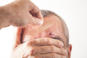 Fototapeta premium Hand showing adhesive bandage on man wound.
