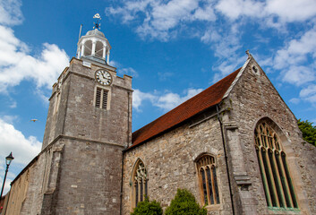 Fototapeta premium Close up isolated view of the historical Church of St Thomas the Apostle, the main Anglican church in Lymington, UK. Image features the exterior view including the watch tower