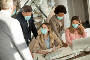 Group of business people have a meeting and working in office and wear masks as protection from corona virus