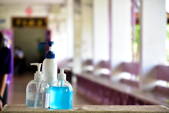 New normal, hand sanitizer, alcohol gel and hand soap on table in front of classroom. Concept for pretecting and preventing coronavirus or covid-19 and germs.