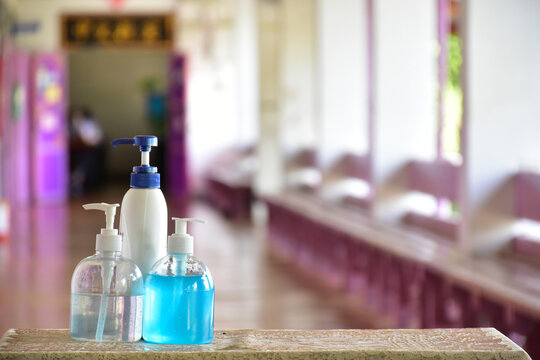 New normal, hand sanitizer, alcohol gel and hand soap on table in front of classroom. Concept for pretecting and preventing coronavirus or covid-19 and germs.