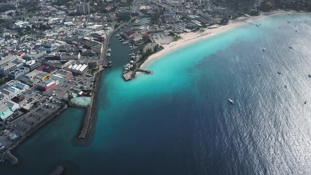 Top down view of Bridgetown, Barbados with house, Constitution River and the sea with beach and yachts