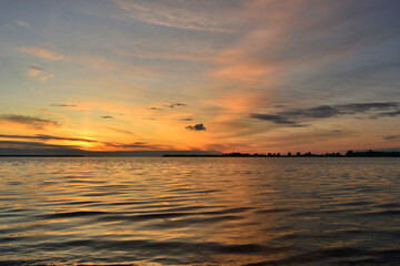 Dramatic background of the sunset with purple sky and sea.