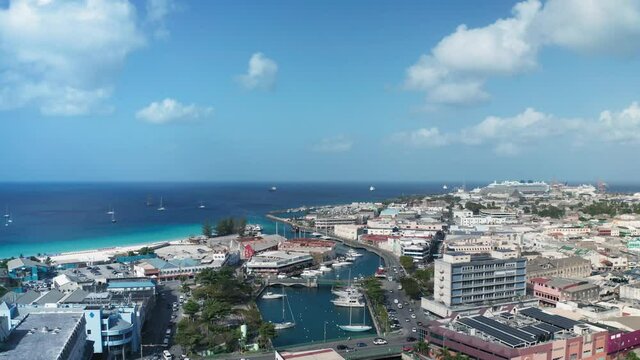 An air drone moves over Bridgetown, Barbados on the sunny day. On the horizon the sea turns into the sky