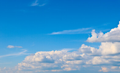 Naklejka na ściany i meble Cumulus clouds in the blue sky. Copy space
