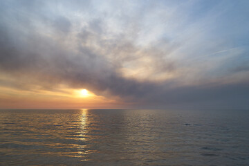 Sea sunset. Smoke wildfires sweeping across the sky.