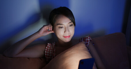 Naklejka premium Woman work on mobile phone at living room