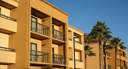 rental apartment buildings in a row with palm tree