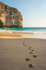 Footprints on Kelingking beach in evening sunset, Nusa Penida island in Indonesia