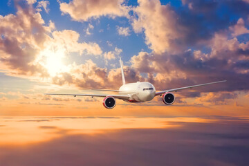 Fototapeta na wymiar Jet passenger plane flies at sunset in the clouds.